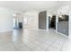 Open floor plan living room features tile flooring and an archway leading to the kitchen at 3623 Weatherfield Dr, Kissimmee, FL 34746