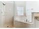 Bathroom with corner soaking tub and walk-in shower at 3623 Weatherfield Dr, Kissimmee, FL 34746