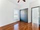 Bright bedroom with wood floors, large closet, and access to another room at 3623 Weatherfield Dr, Kissimmee, FL 34746