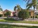 Single-story home with tile roof, landscaping, and two-car garage at 3623 Weatherfield Dr, Kissimmee, FL 34746