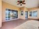 Covered screened patio with sliding doors and view of backyard at 3623 Weatherfield Dr, Kissimmee, FL 34746