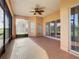 Relaxing screened porch with ceiling fan and access to backyard at 3623 Weatherfield Dr, Kissimmee, FL 34746