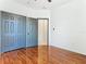 Bedroom with double door closet and wood floors at 3623 Weatherfield Dr, Kissimmee, FL 34746