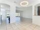 Open concept dining room with tile flooring and view into the living room at 3623 Weatherfield Dr, Kissimmee, FL 34746