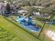 Aerial view of a playground with modern equipment and shaded areas at 3623 Weatherfield Dr, Kissimmee, FL 34746