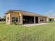 Single story house with screened patio and well manicured lawn at 3623 Weatherfield Dr, Kissimmee, FL 34746