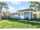 Quaint blue house with a front yard and landscaping at 1701 Minnesota Ave, Saint Cloud, FL 34769