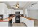 Modern kitchen with butcher block countertops and stainless steel appliances at 1701 Minnesota Ave, Saint Cloud, FL 34769