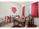 Charming dining room with a wooden table and red accents at 348 Sand Ridge Dr, Davenport, FL 33896