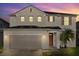 Two-story house with a two car garage and front yard at 348 Sand Ridge Dr, Davenport, FL 33896