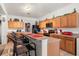 Kitchen with light wood cabinets and a breakfast bar at 348 Sand Ridge Dr, Davenport, FL 33896