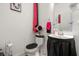 Clean bathroom with a pedestal sink and dark accents at 348 Sand Ridge Dr, Davenport, FL 33896