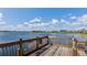 Serene lake view from a wooden deck, perfect for relaxation at 14132 Murcott Blossom Blvd, Winter Garden, FL 34787
