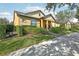 One-story home with yellow siding and a covered porch at 14132 Murcott Blossom Blvd, Winter Garden, FL 34787