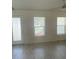 Bright living room with wood-look flooring and windows at 13394 Sw 106Th St, Dunnellon, FL 34432