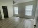 Spacious bedroom with two windows and wood-look flooring at 13394 Sw 106Th St, Dunnellon, FL 34432