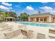 Community pool with lounge chairs, gazebo, and clubhouse at 2335 Caravelle Cir, Kissimmee, FL 34746