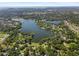 Wide aerial view of a community situated around a lake at 646 Primrose Willow Way, Apopka, FL 32712