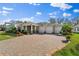 House exterior with a large driveway and landscaping at 646 Primrose Willow Way, Apopka, FL 32712