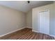 Simple bedroom with wood-look floors and built-in closet at 1313 Olive Ave, Sanford, FL 32771