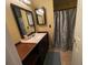 Clean bathroom with single sink vanity, shower, and decorative curtain at 2456 Sweetwater Club Cir # 20, Kissimmee, FL 34746