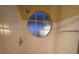 Shower stall with circular window, tile walls, and a shower head at 2456 Sweetwater Club Cir # 20, Kissimmee, FL 34746