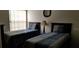 Cozy bedroom featuring two twin-size beds and ample natural light at 2456 Sweetwater Club Cir # 20, Kissimmee, FL 34746
