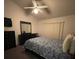 Spacious bedroom with a large bed, dresser, and ceiling fan at 2456 Sweetwater Club Cir # 20, Kissimmee, FL 34746