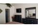 Main bedroom with dresser, large mirror and ensuite bathroom at 2456 Sweetwater Club Cir # 20, Kissimmee, FL 34746