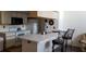 Galley kitchen with white cabinetry and breakfast bar at 2456 Sweetwater Club Cir # 20, Kissimmee, FL 34746