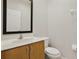 Clean bathroom with wood vanity and a toilet at 3004 Bird Of Paradise Ln, Kissimmee, FL 34747