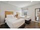 Two twin beds in a bright bedroom with wood floors at 3004 Bird Of Paradise Ln, Kissimmee, FL 34747