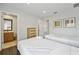 Two twin beds in a bedroom with access to a bathroom at 3004 Bird Of Paradise Ln, Kissimmee, FL 34747