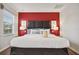Bedroom with king-size bed and red accent wall at 3004 Bird Of Paradise Ln, Kissimmee, FL 34747