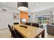 Dining area with wood table and chairs, open to living room at 3004 Bird Of Paradise Ln, Kissimmee, FL 34747