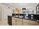 Kitchen with granite countertops, double sink, and black appliances at 3004 Bird Of Paradise Ln, Kissimmee, FL 34747