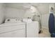 Laundry room with washer, dryer, and shelving at 3004 Bird Of Paradise Ln, Kissimmee, FL 34747