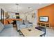 Open living room with gray sofas, coffee table and kitchen view at 3004 Bird Of Paradise Ln, Kissimmee, FL 34747