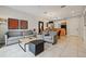 Open living room with gray sofas, coffee table, and view of kitchen at 3004 Bird Of Paradise Ln, Kissimmee, FL 34747