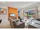 Living room with gray sofas, coffee table, and access to a patio at 3004 Bird Of Paradise Ln, Kissimmee, FL 34747