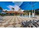 Community pool area with lounge chairs and umbrellas at 3004 Bird Of Paradise Ln, Kissimmee, FL 34747