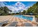 Inviting resort-style pool with ample lounge chairs and umbrellas at 3004 Bird Of Paradise Ln, Kissimmee, FL 34747