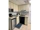 Small kitchen with appliances and corner sink at 6165 Carrier Dr # 2113, Orlando, FL 32819