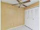 Empty bedroom with ceiling fan and double closet at 6295 River Run Pl # 199, Orlando, FL 32807