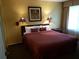 King-size bed and wood furniture in a well-lit bedroom at 6337 Parc Corniche Dr # 2106, Orlando, FL 32821