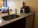 Kitchen sink with granite countertop and various supplies at 6337 Parc Corniche Dr # 2106, Orlando, FL 32821