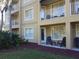 Ground level exterior view of building with patio furniture at 6337 Parc Corniche Dr # 2106, Orlando, FL 32821