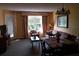 Living room with sofa, armchair, and dining table at 6337 Parc Corniche Dr # 2106, Orlando, FL 32821