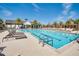 Community pool with lounge chairs and a large deck at 8795 Ribault Ave, Orlando, FL 32832