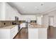 Modern kitchen with white cabinets, granite countertops, and stainless steel appliances at 8795 Ribault Ave, Orlando, FL 32832